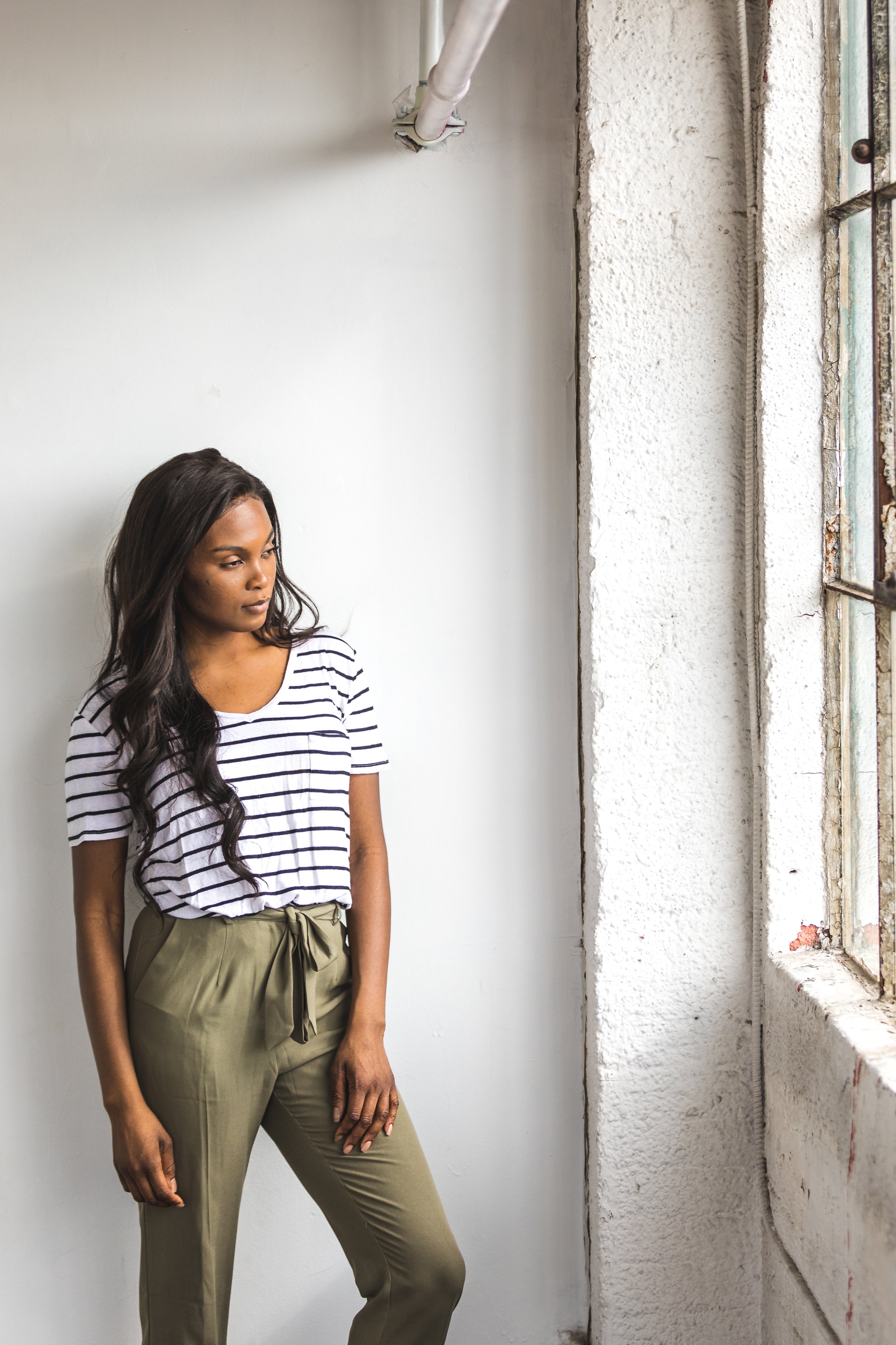 files/young-woman-poses-in-front-of-a-large-window.jpg